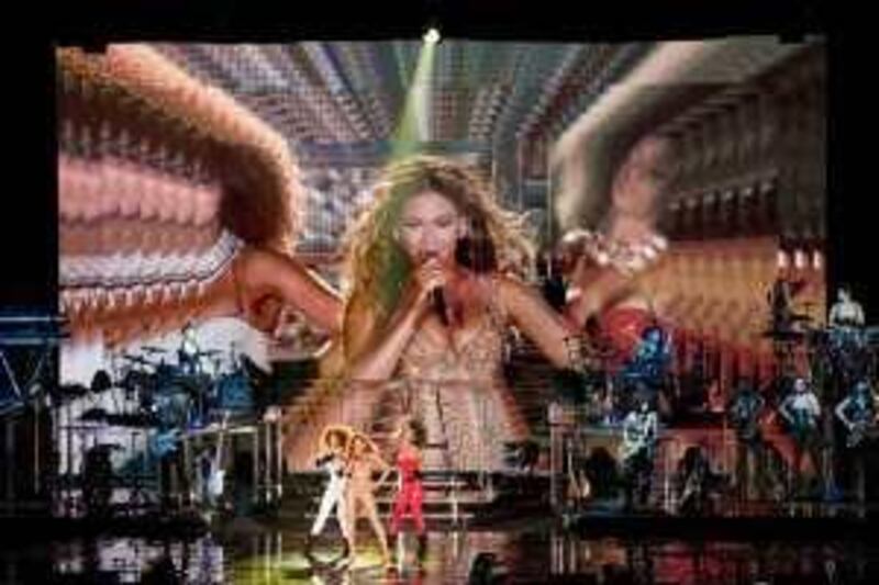 U.S. singer Beyonce, center, performs at the F1 Rocks concert on Saturday Sept. 26, 2009, in Singapore.  (AP Photo/Joan Leong) ** EDITORIAL USE ONLY **