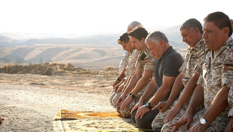 King Abdullah II of Jordan (centre) and his son, Crown Prince Hussein (second left), next to him, praying with army officers during a ceremony at the Jordan Valley site of Baqura, east of the Jordan River, one day after a deal dating from the historic 1994 peace treaty between the desert kingdom and Israel allowing Israeli farmers to lease two sites along their common border ran out. AFP