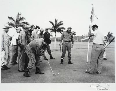 Che Guevarra and Fidel Castro playing golf.