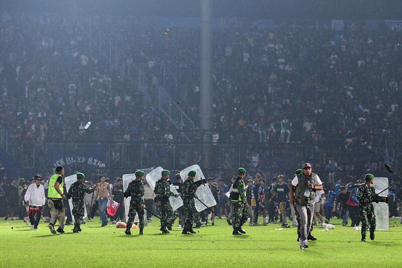 The Indonesian army on the pitch after a football match between Arema FC and Persebaya Surabaya at Kanjuruhan stadium in Malang, East Java. AFP