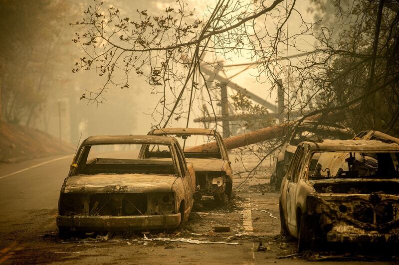 Abandoned cars, scorched by the wildfire, line Pearson Road in Paradise. AP Photo