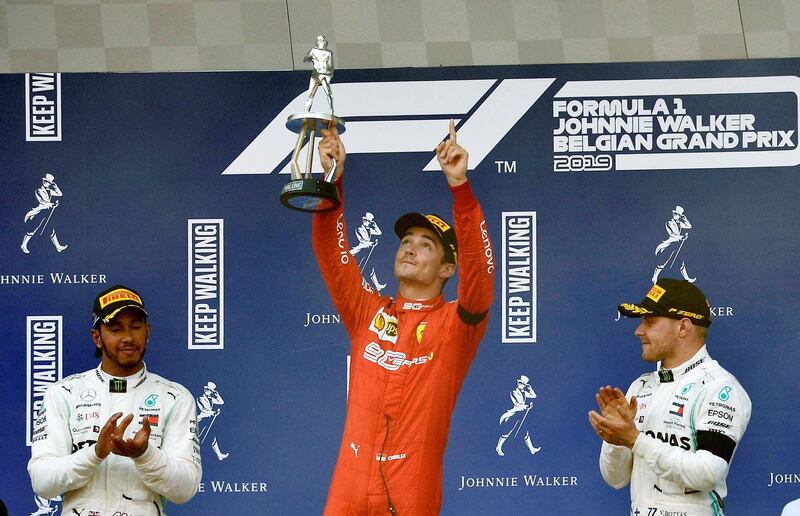 Formula One F1 - Belgian Grand Prix - Spa-Francorchamps, Stavelot, Belgium - September 1, 2019  Ferrari's Charles Leclerc celebrates with a trophy on the podium after winning the race as he applauded by second placed Mercedes' Lewis Hamilton and third placed Mercedes' Valtteri Bottas   REUTERS/Johanna Geron