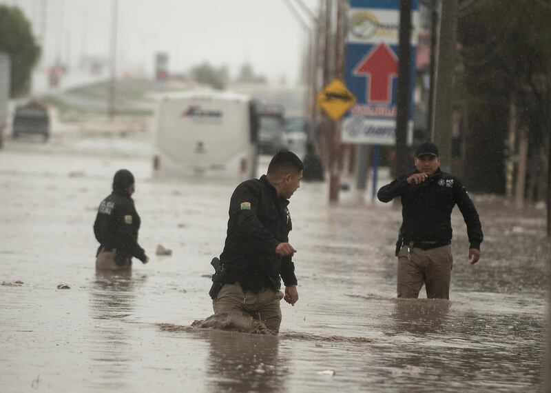 epa08567998 People wade through severe floods, caused by heavy rains, affecting the city of Saltillo in the northern state of Coahuila, Mexico 26 July 2020. Tropical storm Hanna has left flooding in its wake in several cities in northeastern Mexico and in the next few hours will generate torrential rains with winds of up to 90 kilometers, civil protection authorities reported.  EPA/Miguel Sierra