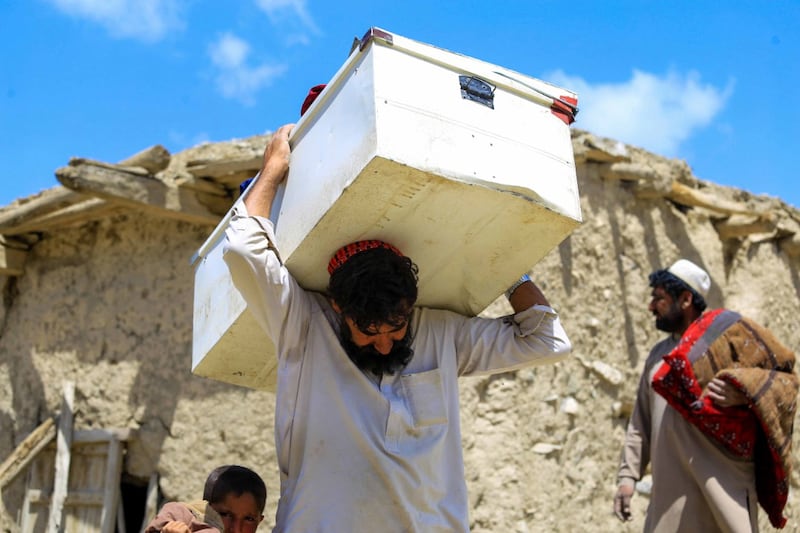 People salvage their belongings from a damaged house in the earthquake-affected Gayan village in the Paktika province, Afghanistan. EPA