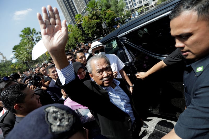 Former Malaysian prime minister Muhyiddin Yassin waves outside Kuala Lumpur Court Complex. Reuters