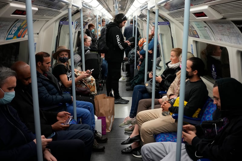 People travel on a London underground tube train on the Jubilee Line, in London, during the pandemic. AP Photo
