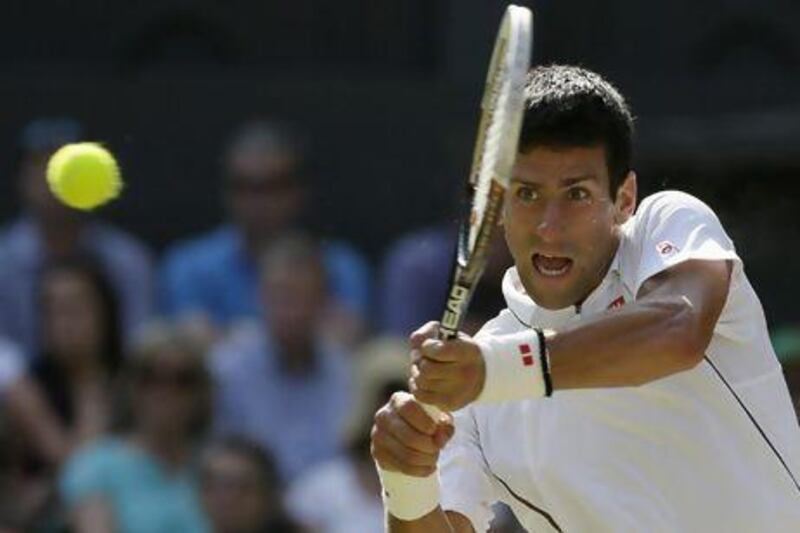 Novak Djokovic of Serbia returns to Juan Martin Del Potro of Argentina during their men's singles semifinal match at the All England Club in Wimbledon on Friday. Alastair Grant / AP Photo