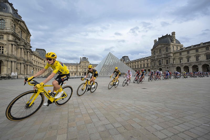 Jumbo-Visma's Jonas Vingegaard rides past the Louvre Pyramid. AFP