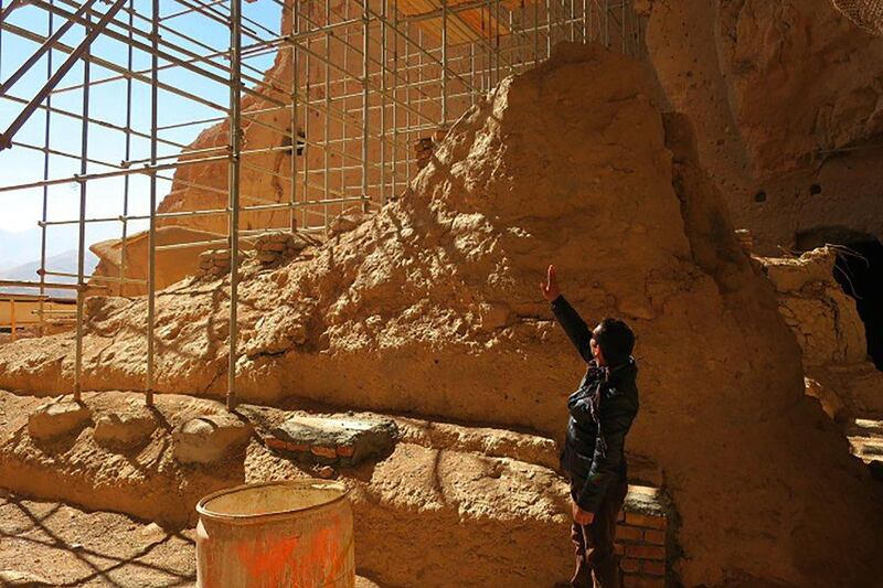 Afghan archaeological guard, Hakim Safam, stands in front of the reconstructed foot of the Salsal Buddha, on November 6, 2016, in Bamiyan province. The statue was about 55 metres high before being destroyed in 2001 by the Taliban. Agence France-Presse 