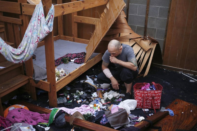 A resident looks at belongs scattered on a floor at a damaged home after Hurricane Michael hit in Panama City, Florida. Bloomberg