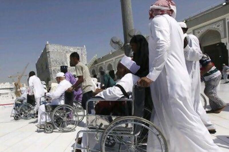 Pilgrims seated in wheelchairs circle the Kaaba and pray at the Grand Mosque during Tawaf al-Wadaa (Farewell Tawaf) on the last day of the Haj.