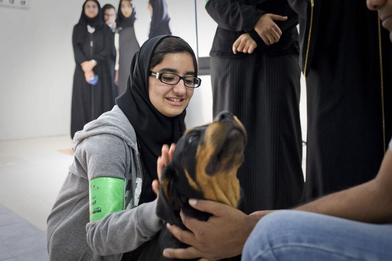 Asma Omar, 15, pets a young Rottweiler puppy called Kira.