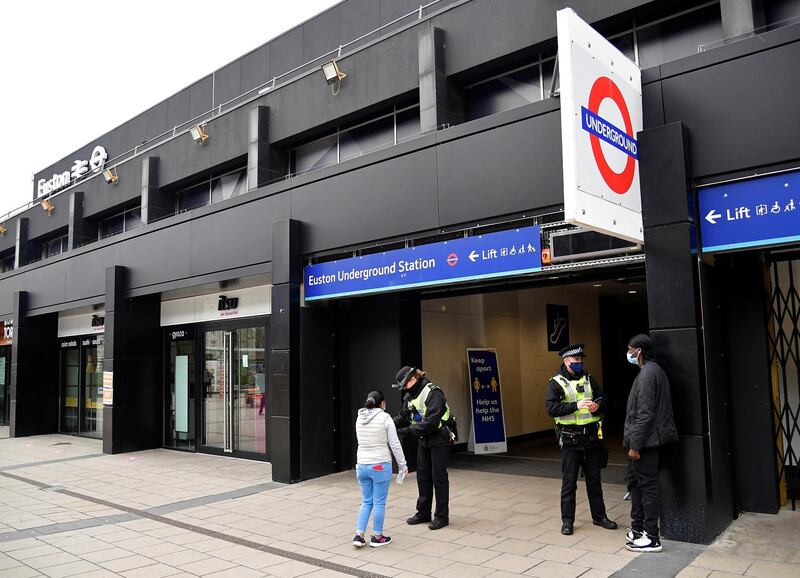 British Transport Police officers check on travellers as they arrive at Euston rail station in London. Reuters