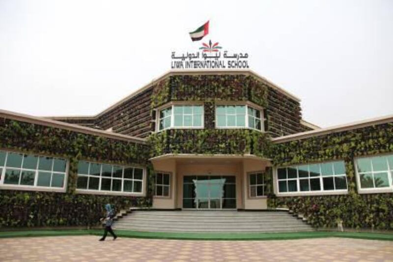 A staff member walks past the main entrance of Liwa International School in Al Ain on Wednesday, April 13, 2011. The school is the first in the UAE to be draped by plants in an effort to save energy and promote a environmentally friendly attitude. Pawel Dwulit  /The National