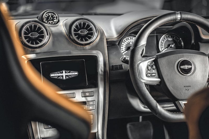 The reassuringly large steering wheel is covered in leather and Alcantara. David Brown Automotive