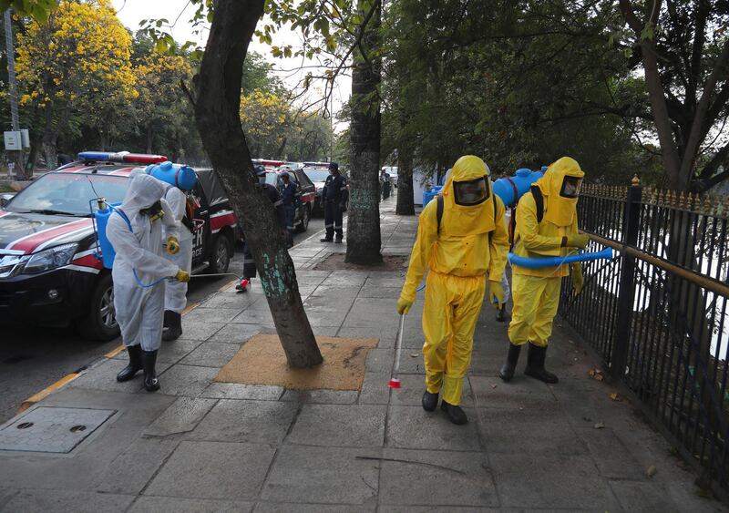 Members of disaster response force spray disinfectants as a precautionary measure against COVID-19 in Hyderabad, India. AP Photo