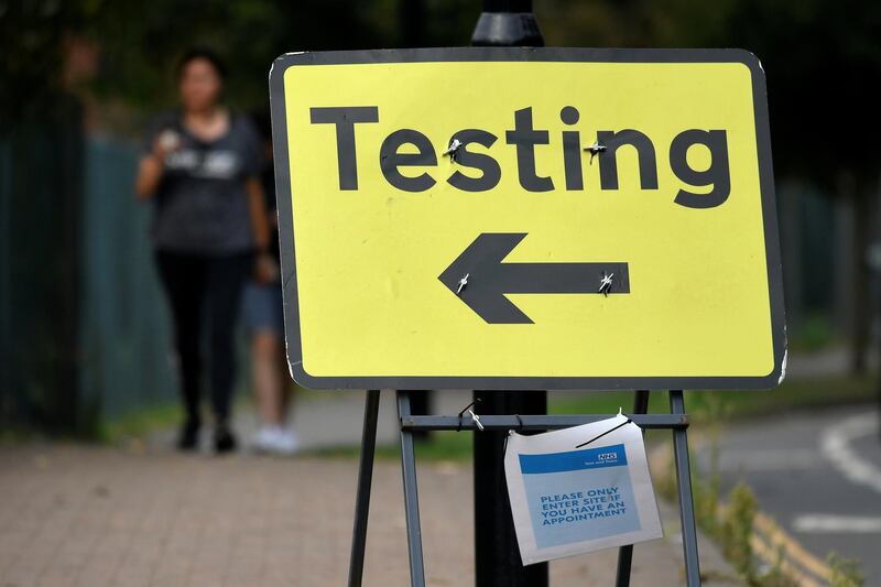 Signage is seen at an entrance of a drive-in coronavirus testing centre amid an outbreak of the coronavirus disease (COVID-19) at Twickenham in London, Britain. REUTERS