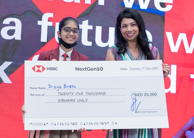 Sreya Binesh accepts her prize from Sabrin Rahman