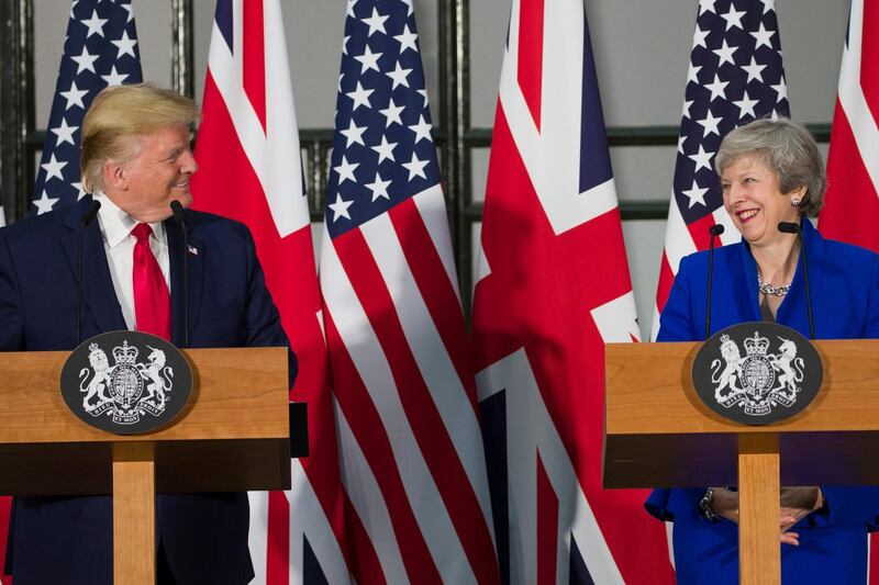 President Donald Trump and British Prime Minister Theresa May smile at each other during a news conference at the Foreign Office, Tuesday, June 4, 2019, in central London. (AP Photo/Alex Brandon)