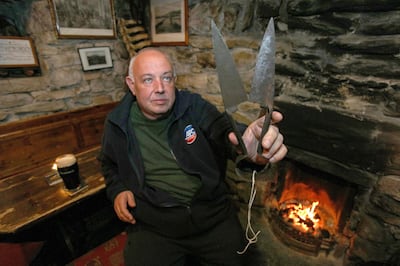 Owner of the Lynotts pub Mick Lynch, shows the 'infamous' sheep shearers used in movie. AFP
