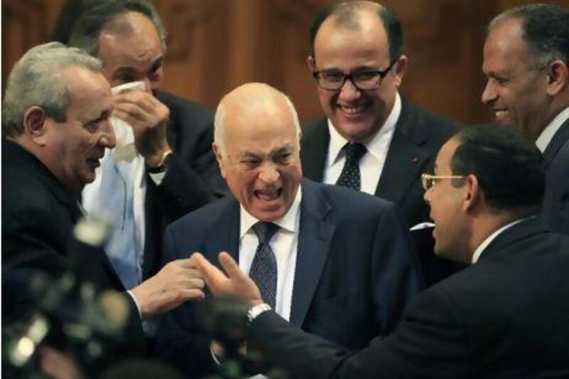 Egyptian foreign minister Nabil Elaraby, centre, laughs as he is surrounded by delegates at the Arab League headquarters in Cairo. After a last minute change of candidates, Mr Elaraby was elected the new secretary-general of the Arab League. Amr Nabil / AP Photo/