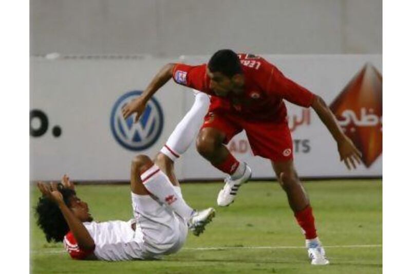 Theyab Awana tumbles to the ground during the match against Lebanon on Sunday. He scored the resultant penalty with a back-heel.