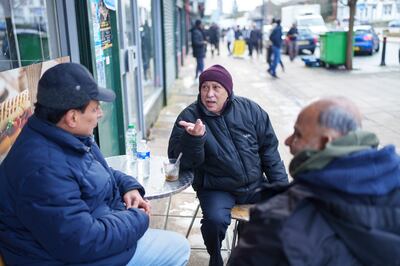 Yemenis chat outside a cafe in the Burngreave district of Sheffield. Dominic Lipinski for The National 