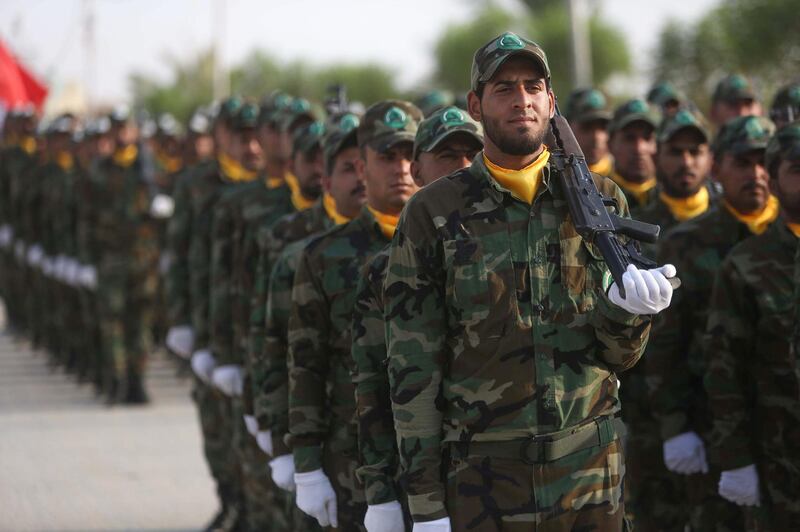 Members of the "Liwa al-Tafuf" 13th Brigade of Iraq's Shiite Muslim Hashed al-Shaabi (Popular Mobilisation units) paramilitary take part in a graduation ceremony at a training centre in the central Iraqi city of Karbala on August 30, 2019.
  / AFP / Mohammed SAWAF
