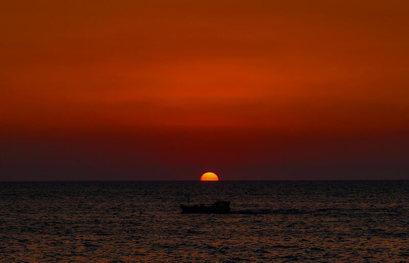 A boat sails during the sunset on the seafront of Beirut, Lebanon.  EPA