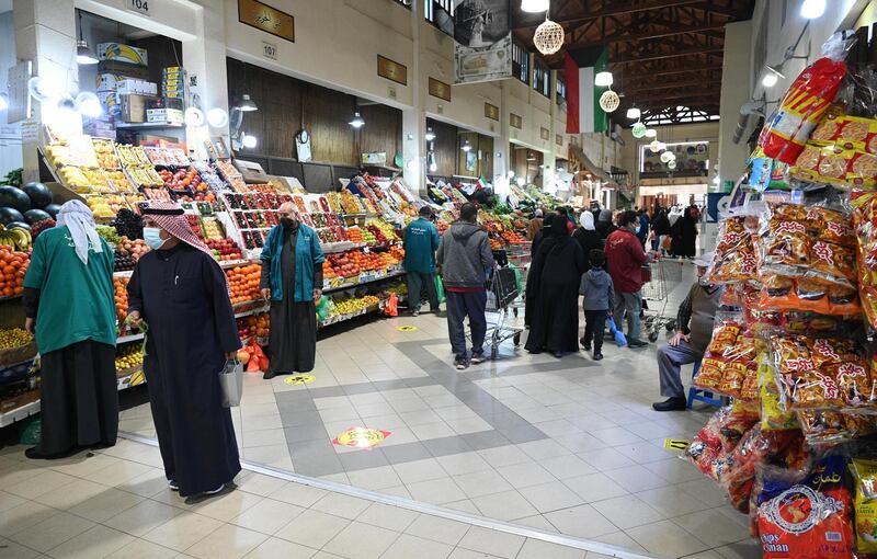 Customers shop at fruit stalls at Souk Al Mubarakiya in Kuwait City. Kuwait's government has cancelled National Day 
and Liberation Day celebrations on February 25 and 26, due to the Covid-19 pandemic. EPA