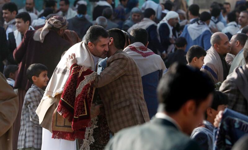 Yemenis greet each other after performing Eid Al-Fitr prayers at a square on the first day of Eid Al Fitr celebrations in Sanaa. EPA