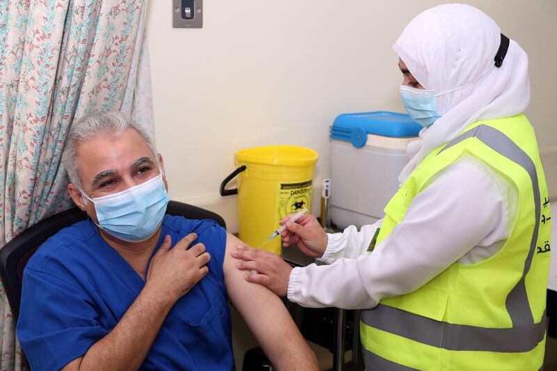 A doctor receives his first dose of the Pfizer-BioNTech Covid-19 vaccine in the Omani capital Muscat.  AFP