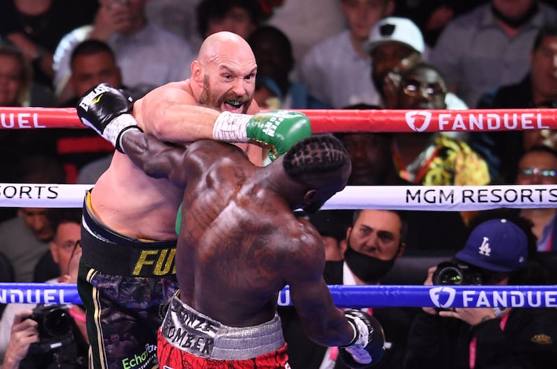 Tyson Fury lands a punch on US challenger Deontay Wilder. AFP