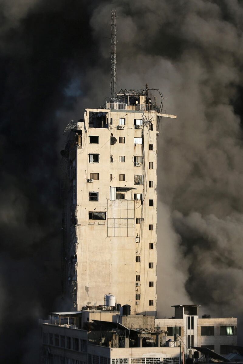 Smoke engulfs a building destroyed by Israeli air strikes amid a flare-up of Israeli-Palestinian violence in Gaza city. Reuters