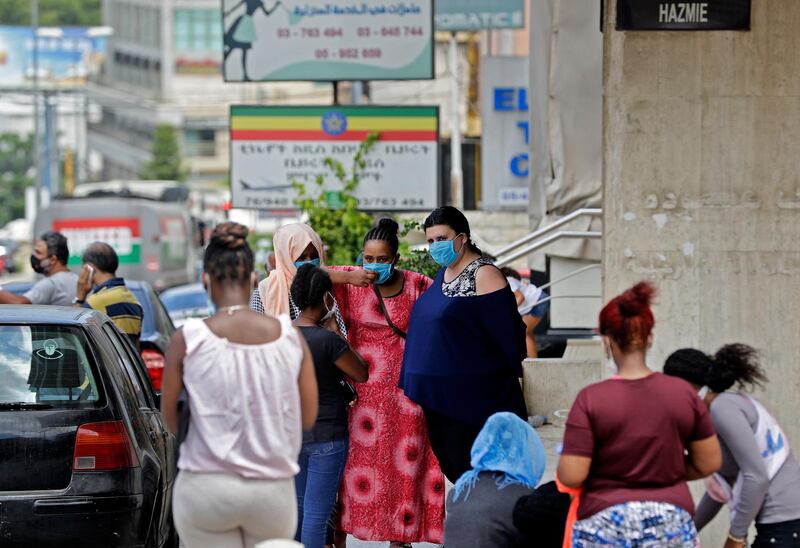 Ethiopian domestic workers who were dismissed by their employers gather with their belongings outside their country’s embassy in Hazmiyeh, east of Beirut, on June 24, 2020. - Around 250,000 migrants -- usually women -- work as housekeepers, nannies and carers in Lebanese homes, a large proportion Ethiopian and some for as little as $150 a month. None are protected by the labour law. (Photo by JOSEPH EID / AFP)