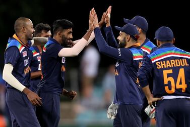 India's captain Virat Kohli (2nd R) congratulates paceman Jasprit Bumrah (2nd L) for his wicket of Shardul Thakur during the third one-day international cricket match between Australia and India at Manuka Oval in Canberra on December 2, 2020. / IMAGE RESTRICTED TO EDITORIAL USE - STRICTLY NO COMMERCIAL USE / AFP / DAVID GRAY / / IMAGE RESTRICTED TO EDITORIAL USE - STRICTLY NO COMMERCIAL USE