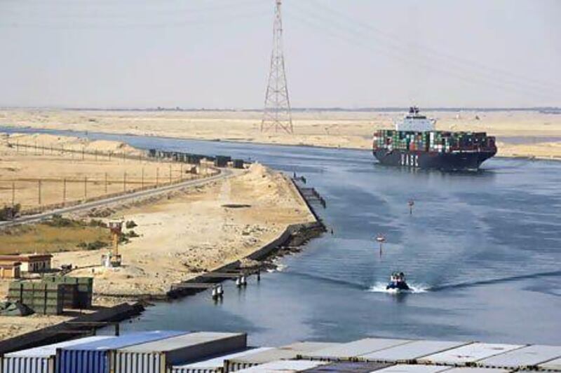 A container ship passes through the Suez Canal. A closure of the canal could add $20 to $25 to the price of a barrel of oil. Kristian Helgesen / Bloomberg News