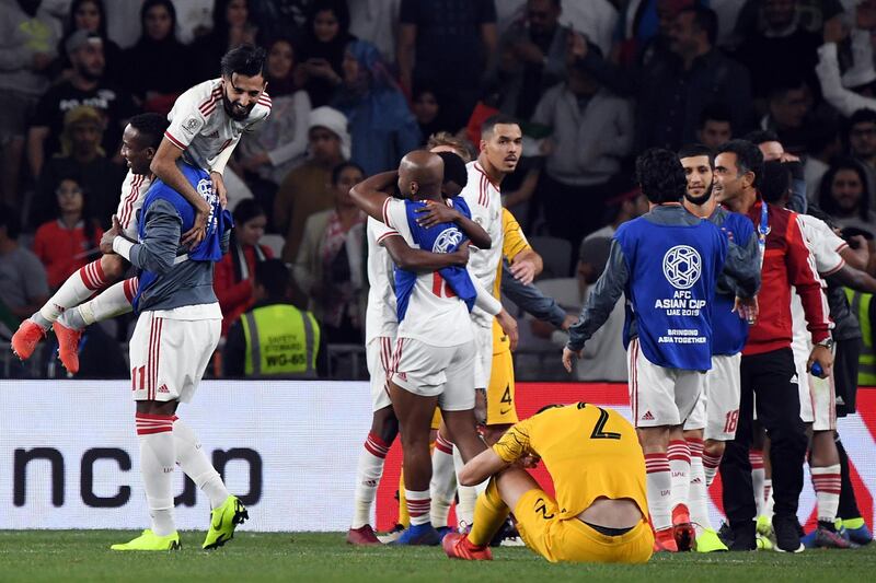 UAE players celebrate as Australian players deal with the devastation of defeat. EPA