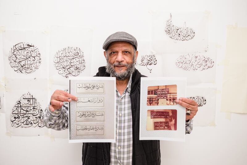 Calligrapher Abdul Fattah with some of the many Arabic language street signs he has written. All photos: Erika Rasmussen for The National