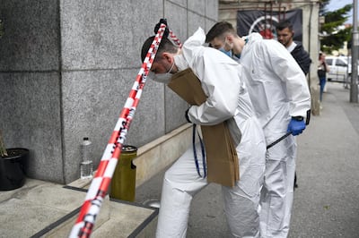 Forensic workers arrive to collect body parts and evidence from a hotel downtown Bucharest, Romania, Friday, June 19, 2020. Gholamreza Mansouri, a former judge from Iran sought by his country to face corruption charges has died after falling from a high floor inside a hotel. Romanian police said only that a man had fallen from a high floor at a hotel in Bucharest, the Romanian capital, and was found dead. (AP Photo/Andreea Alexandru)