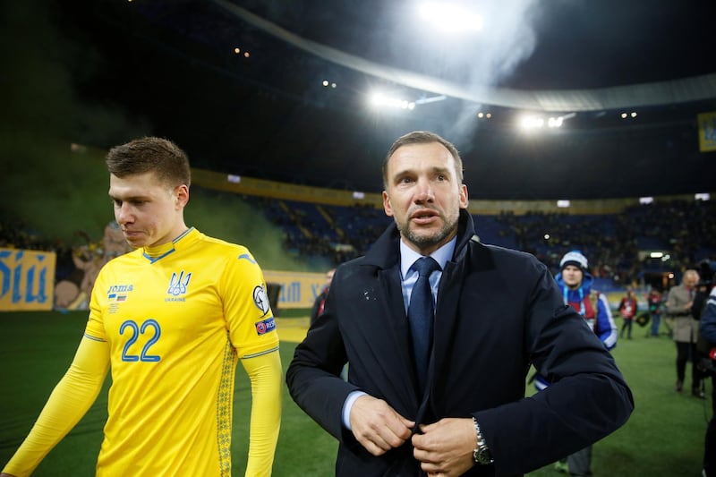 Ukraine's Mykola Matvyenko and coach Andriy Shevchenko celebrate at the end of the match. Reuters