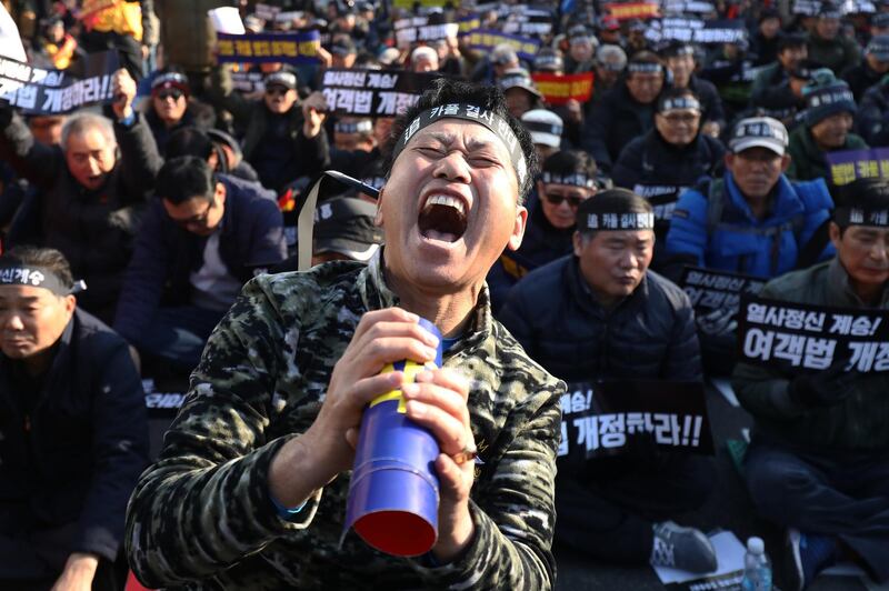 South Korean taxi drivers participate in a rally calling for a car-pooling app to be banned in front of the National Assembly. Getty Images