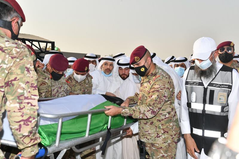 Officials, mask-clad due to the COVID-19 coronavirus pandemic, carrying the bier of the late emir Sheikh Sabah al-Ahmad Al-Sabah upon its arrival for burial at the Sulaibikhat Cemetery.  AFP