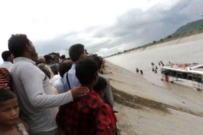 A crowd gathers as a rescue team searches for victims after a bus carrying Hindu pilgrims plunged into a canal near Triveni, 100 kilometres south-west of Kathmandu.