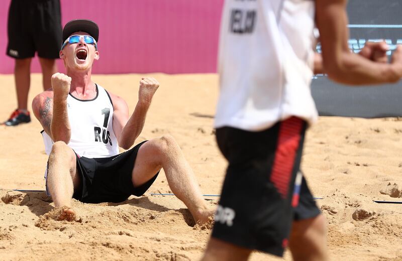 Maxim Sivolap and Igor Velichko of Russia celebrate their win at the FIVB Beach Volleyball World Tour Qinzhou Open in China. Zhong Zhi / Getty Images