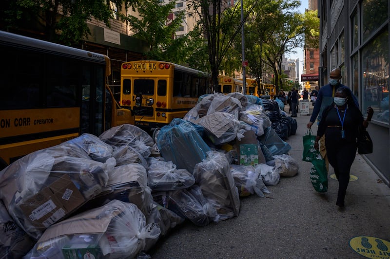 21. New York: Pedestrians pass by trash bags piled on a street in Manhattan. Photo: AFP