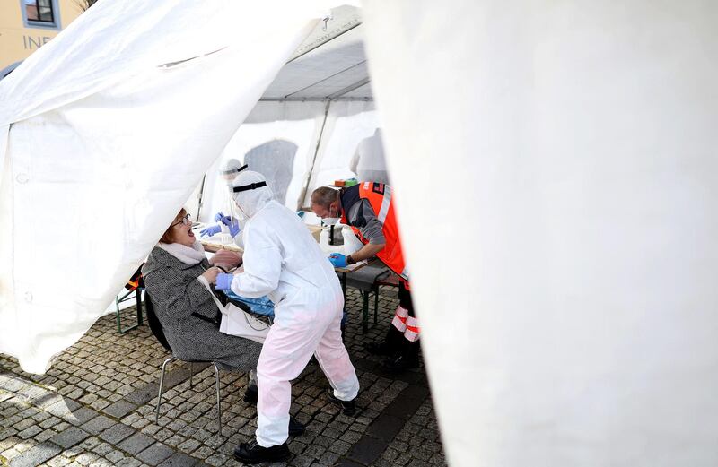 A health worker tests a person at a free of charge Covid-19 test center in Naumburg in the Burgenland region. AFP