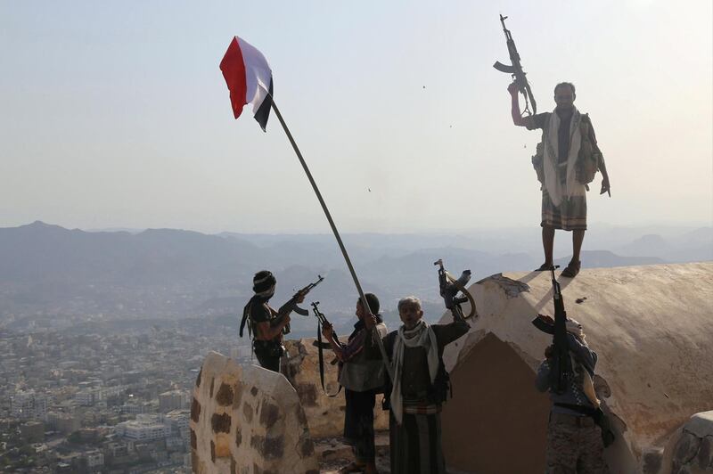 Fighters loyal to Yemen's exiled President Abedrabbo Mansour Hadi stand on top of the Al-Qahira Castle, located on the highest mountain in Yemen's third city Taez, after they seized it from rebel fighters on August 18, 2015. Pro-government and rebel forces have for months fought over Taez, seen as crucial gateway to the rebel-held capital Sanaa. AFP PHOTO / AHMAD AL-BASHA / AFP PHOTO / AHMAD AL-BASHA