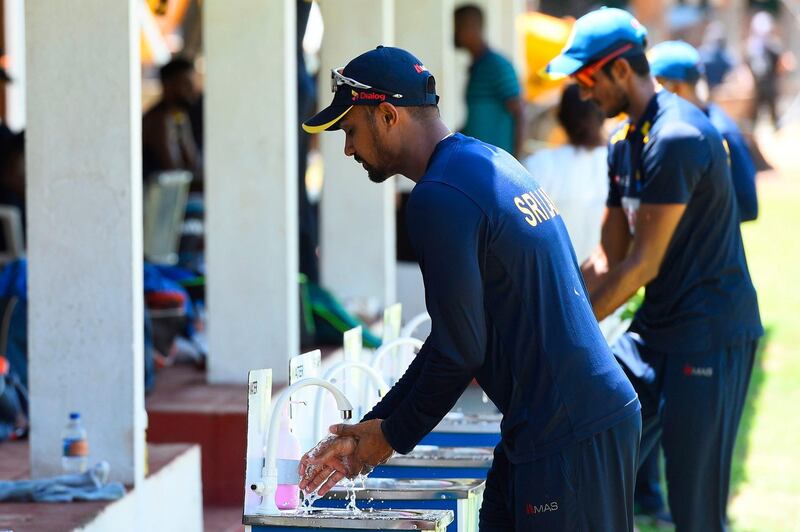 Sri Lankan cricketer Danushka Gunathilaka washes his hands after a practice session at the Colombo Colts Cricket Stadium. AFP