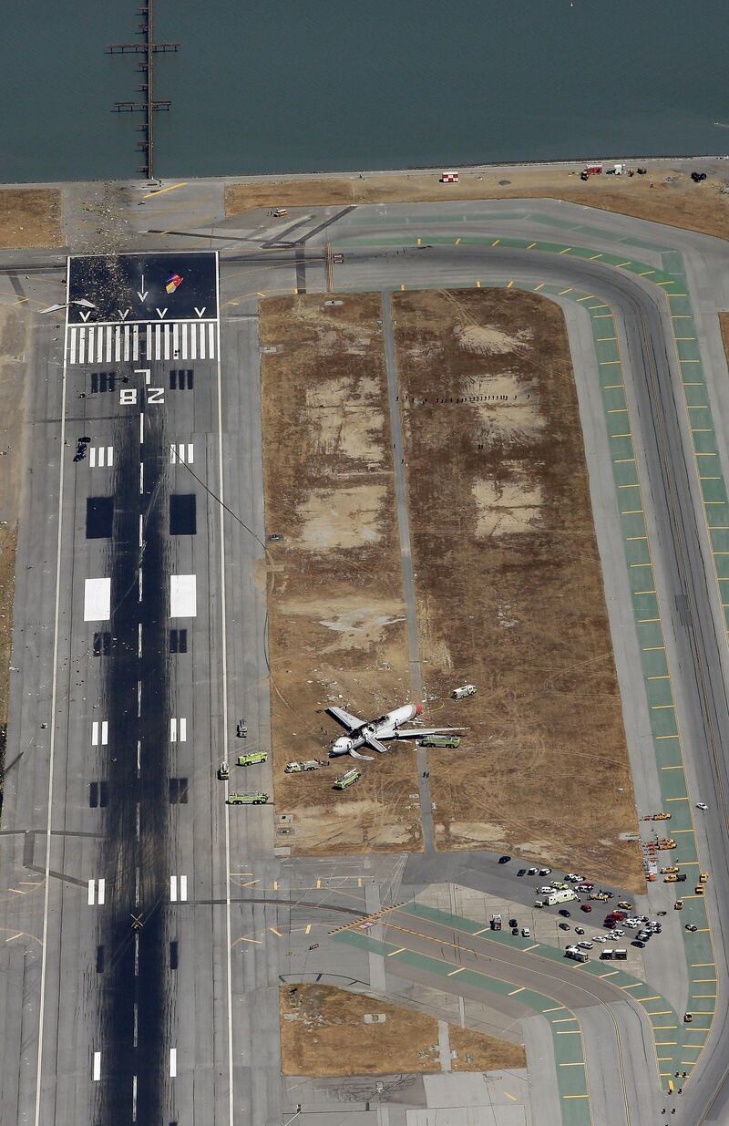 SAN FRANCISCO, CA - JULY 06: A Boeing 777 airplane lies burned on the runway after it crash landed at San Francisco International Airport July 6, 2013 in San Francisco, California. An Asiana Airlines passenger aircraft coming from Seoul, South Korea crashed while landing. There has been at least two casualties reported.   Ezra Shaw/Getty Images/AFP== FOR NEWSPAPERS, INTERNET, TELCOS & TELEVISION USE ONLY ==
 *** Local Caption ***  505122-01-09.jpg